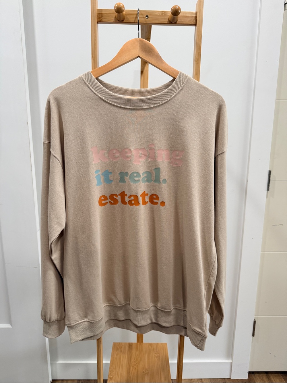Beige Graphic Sweatshirt "keeping it real. estate."